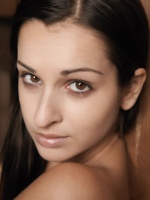 Ennie has super long brunette hair and a gorgeous body